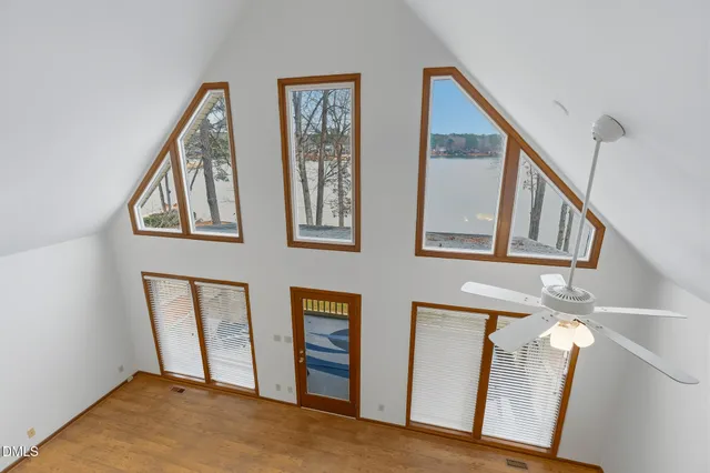 an empty room with closet and fan