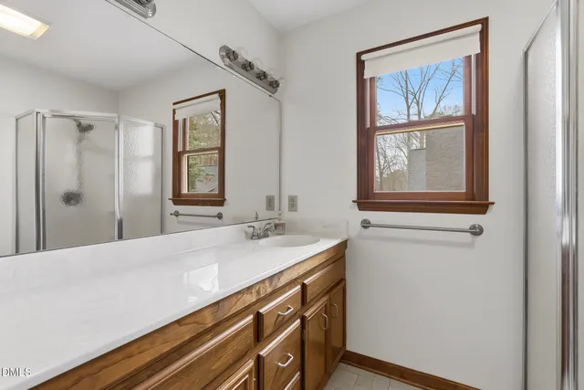 a bathroom with a sink double vanity and a mirror