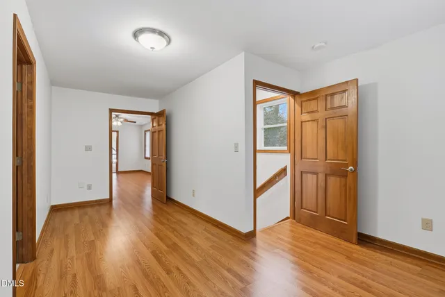 an aerial view of a house with a yard and lake view