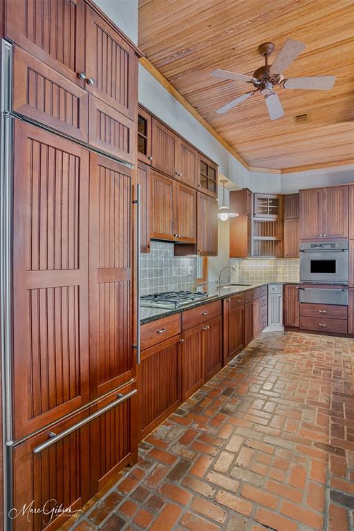 3045 Risinger Drive Shreveport, LA 71119 - Photo 14 of 40 a large kitchen with stainless steel appliances wooden cabinets a stove and a refrigerator