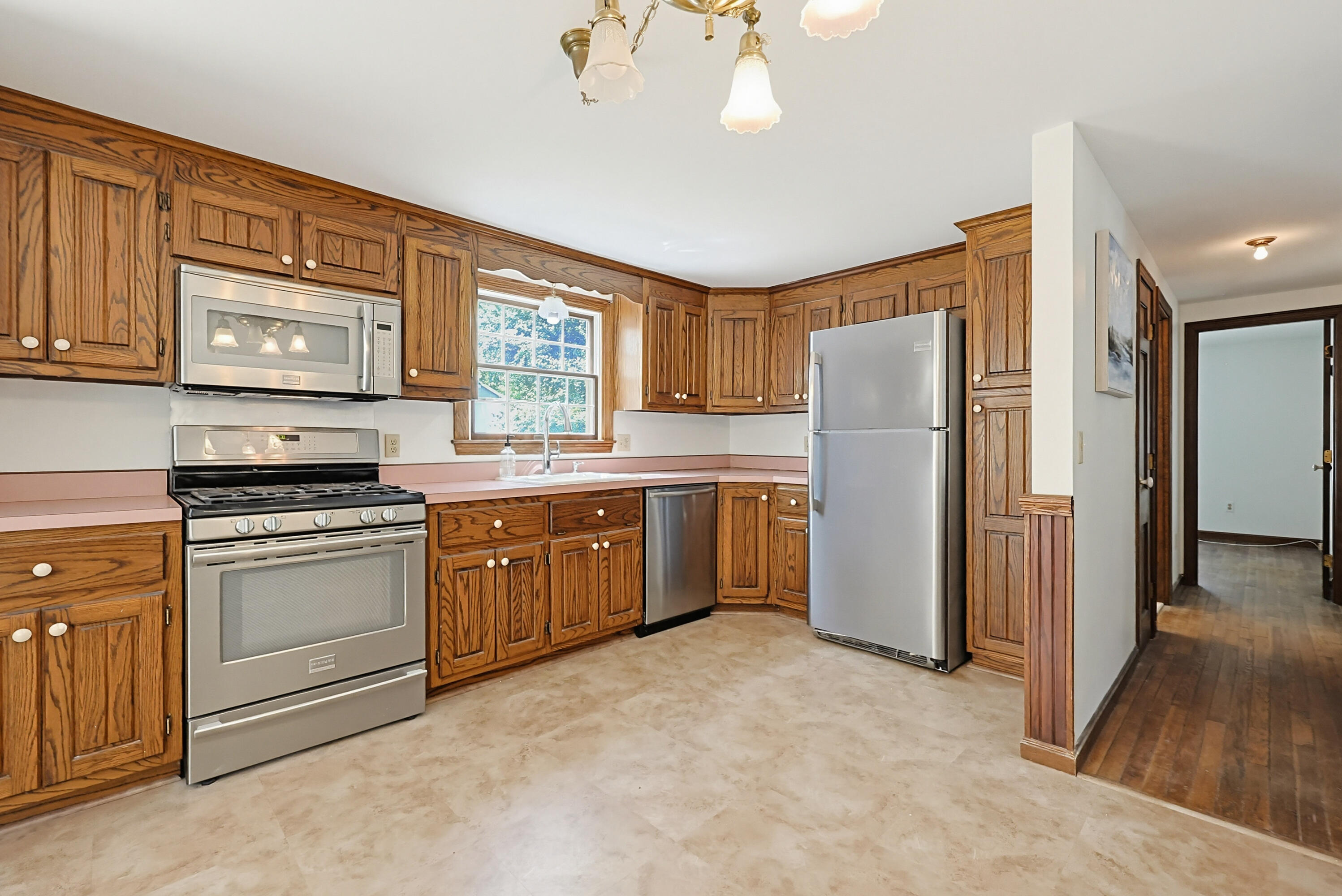 556 Cotuit Road Mashpee, MA 02649 - Photo 13 of 45 a kitchen with a refrigerator sink and cabinets
