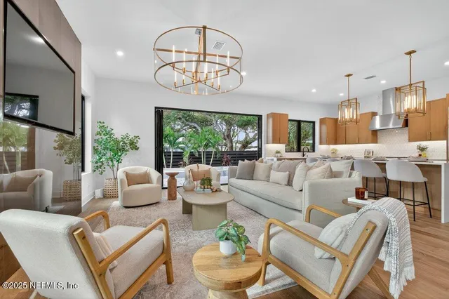 a view of a kitchen with granite countertop a large window and a dining table