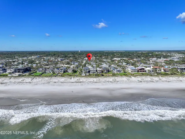 a view of a city with an ocean and front view of a building