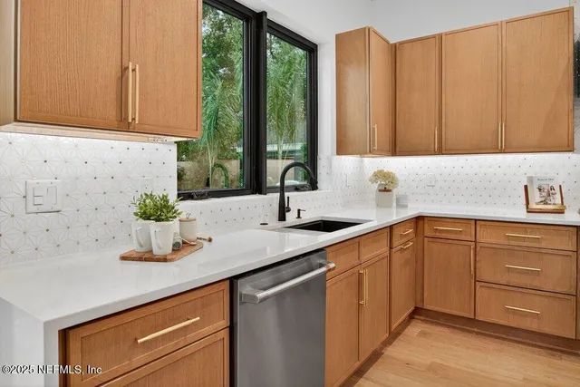 a view of a patio with couches chairs and a fire pit with wooden fence