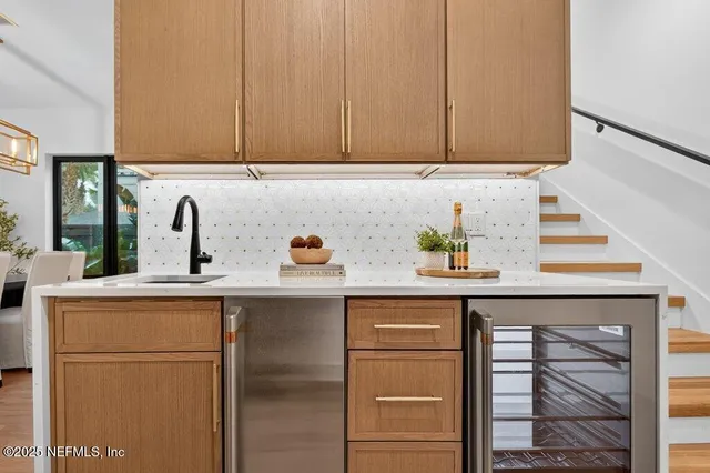 a kitchen with granite countertop a sink and cabinets