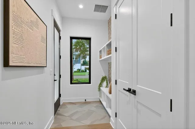 a living room with furniture a flat screen tv and a chandelier