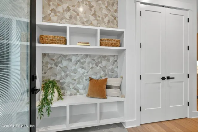 a living room with furniture a flat screen tv and a large window