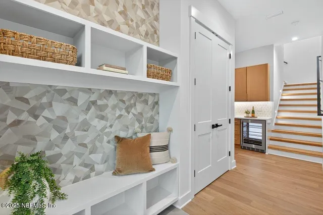 a view of entryway and hall with wooden floor