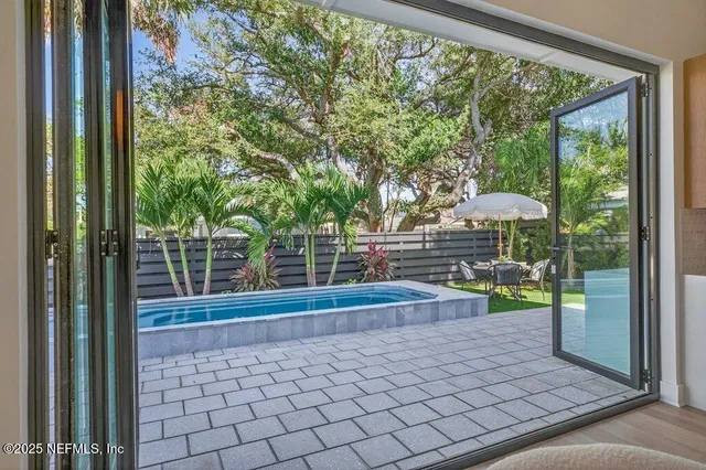 a bedroom with a bed lamp and a potted plant