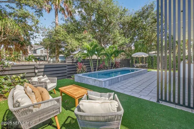 a bedroom with a bed lamp and a potted plant