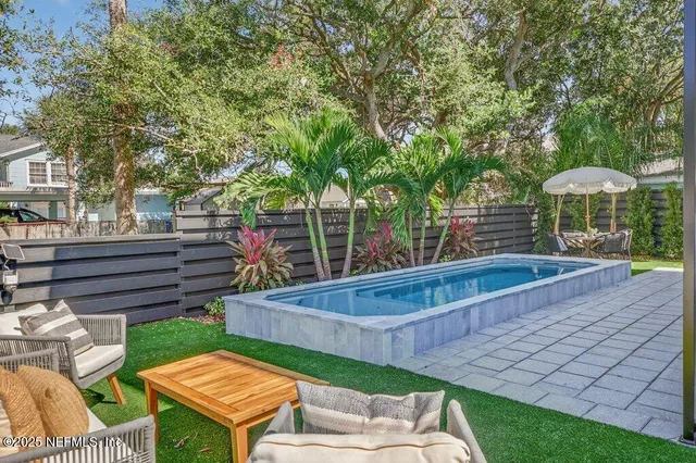 a bedroom with bed and a chandelier