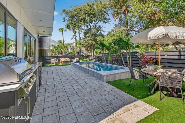 a bedroom with a large bed and windows