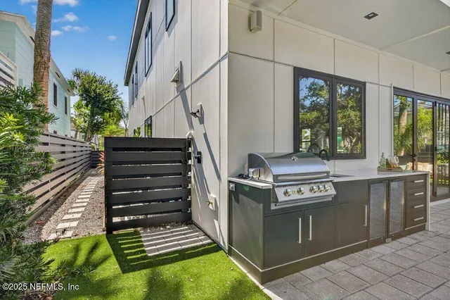 a view of a balcony with chairs and a potted plant