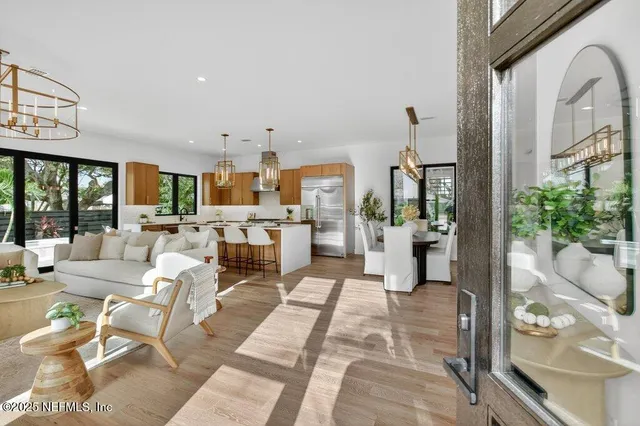 a living room with furniture a flat screen tv and a large window
