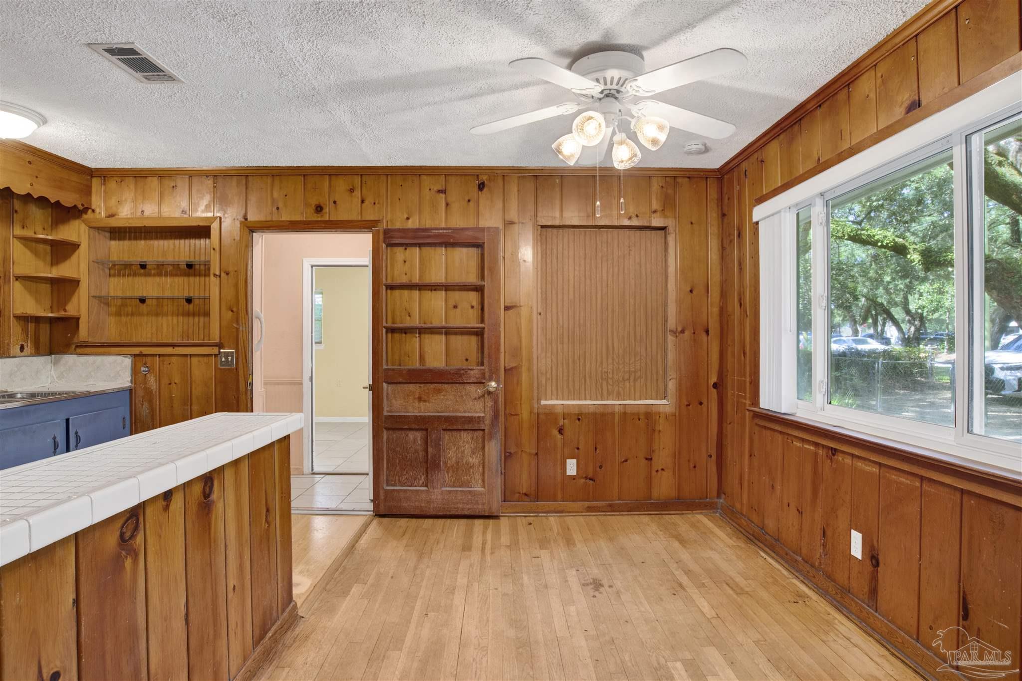 533 Ditmar Street Pensacola, FL 32503 - Photo 15 of 37 wooden floor in an empty room and a window