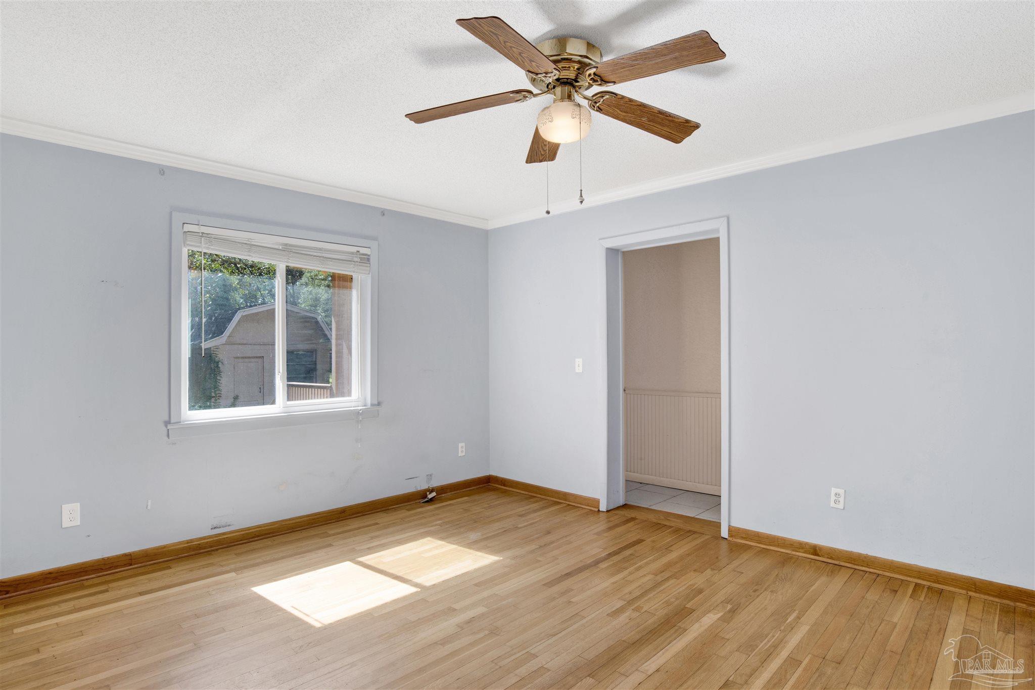533 Ditmar Street Pensacola, FL 32503 - Photo 19 of 37 a view of empty room with wooden floor and fan