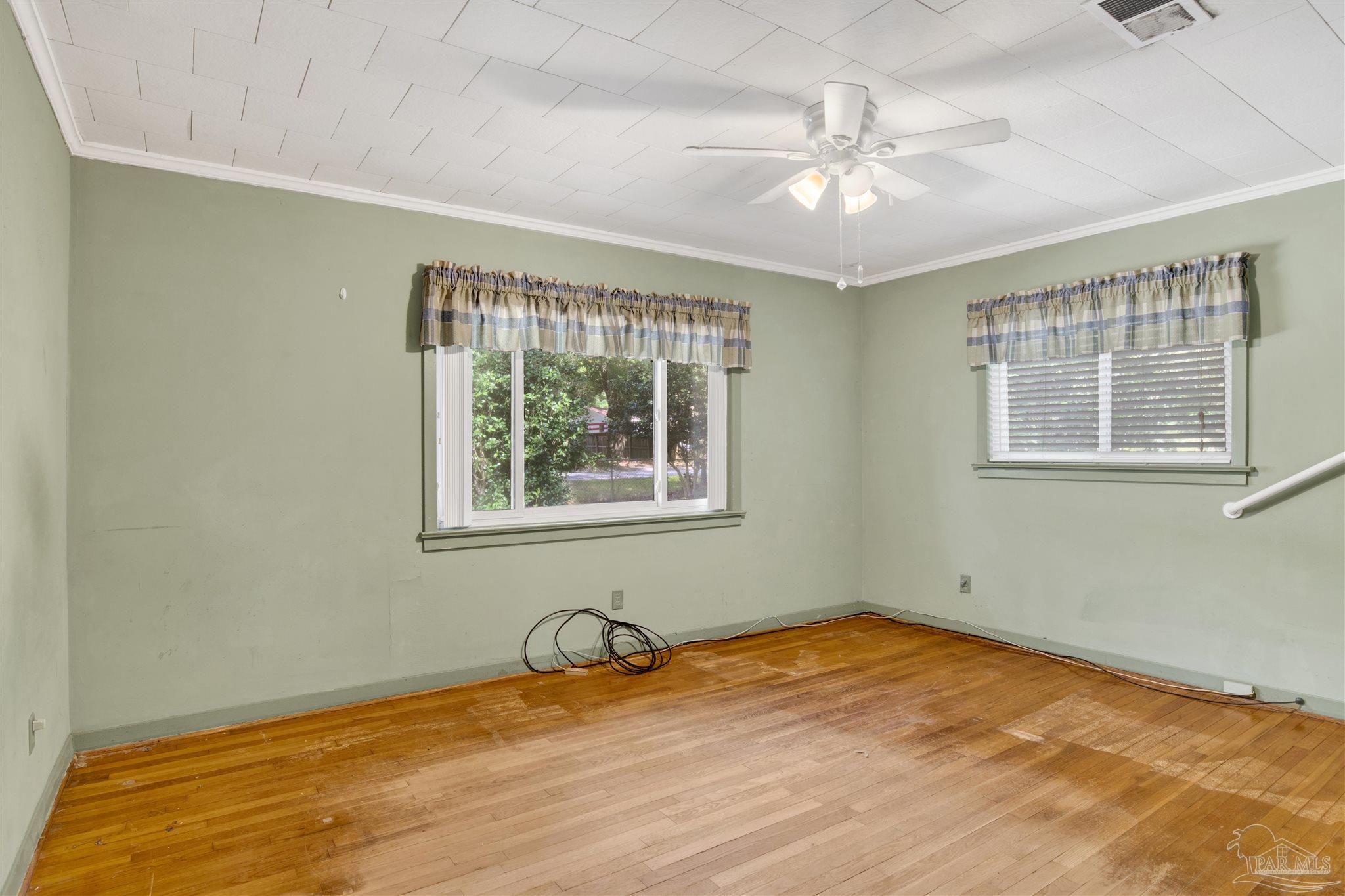 533 Ditmar Street Pensacola, FL 32503 - Photo 23 of 37 a view of a room with wooden floor and a ceiling fan