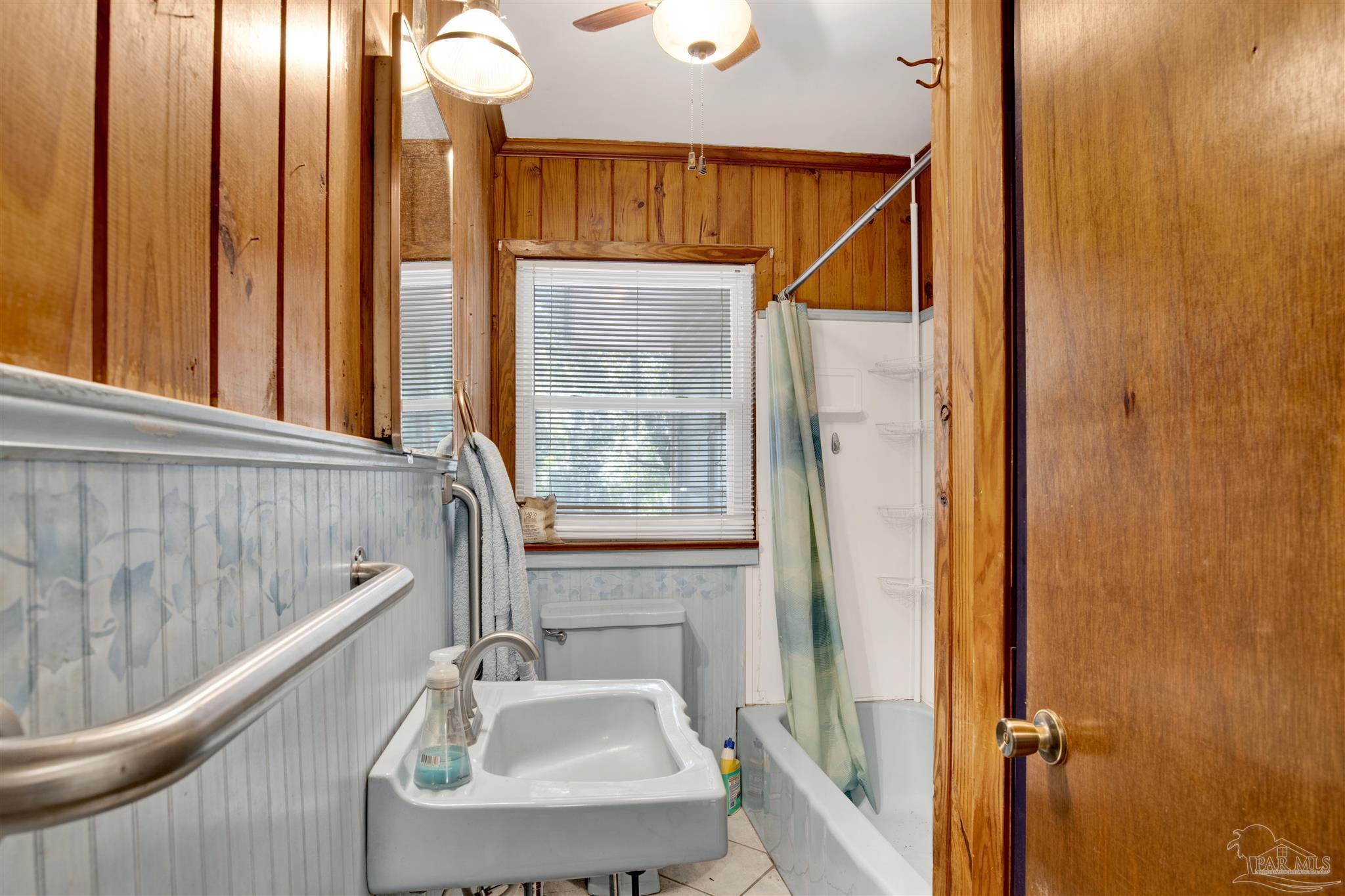 533 Ditmar Street Pensacola, FL 32503 - Photo 24 of 37 a bathroom with a sink a mirror and a shower