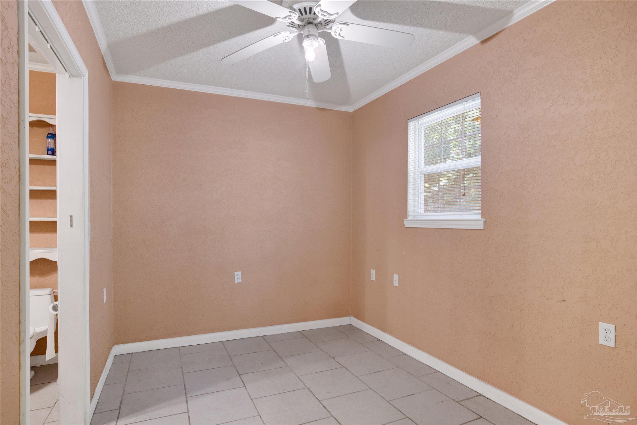 533 Ditmar Street Pensacola, FL 32503 - Photo 33 of 37 an empty room with chandelier fan and windows