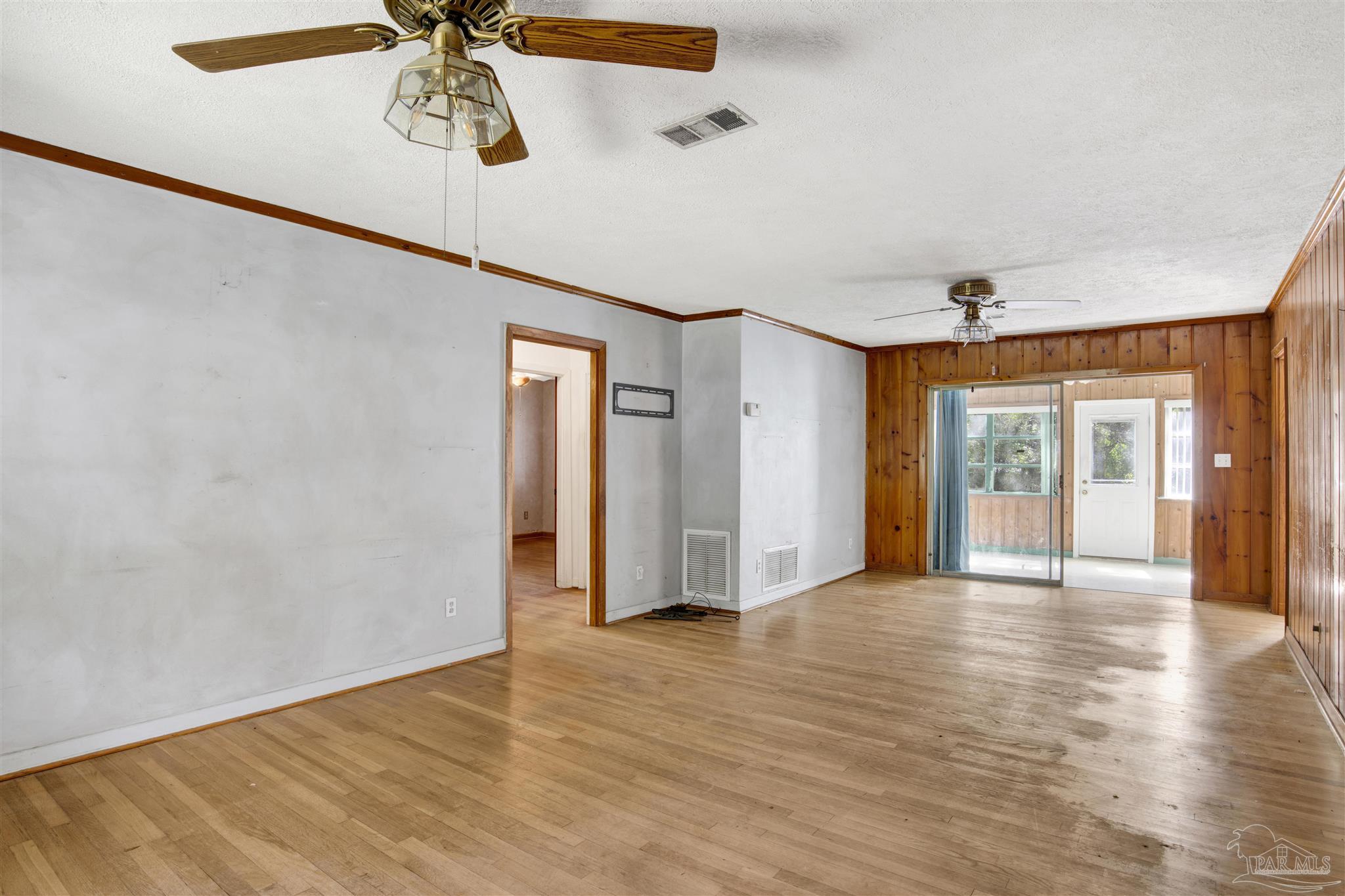 533 Ditmar Street Pensacola, FL 32503 - Photo 7 of 37 a view of an empty room with window and wooden floor