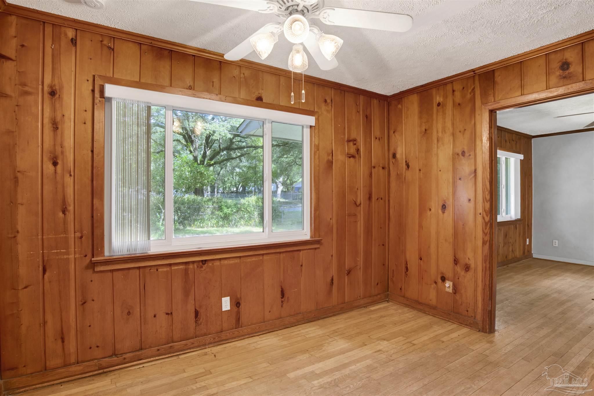 533 Ditmar Street Pensacola, FL 32503 - Photo 9 of 37 an empty room with wooden floor and windows
