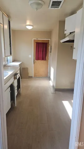 a view of a hallway and a livingroom with furniture