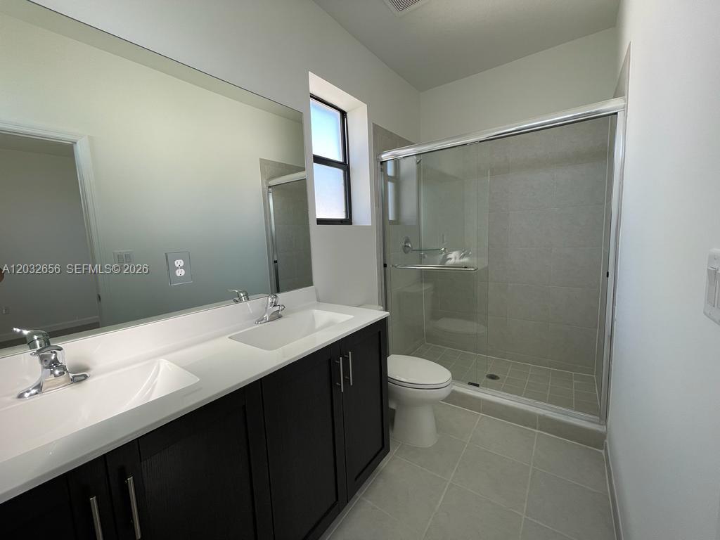10144 Southwest 228th Terrace Miami, FL 33190 - Photo 15 of 23 a bathroom with a sink and a mirror