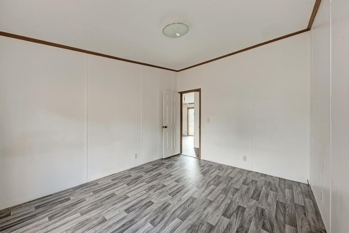 187 Horseshoe Bend Road San Marcos, TX 78666 - Photo 23 of 38 Unfurnished room with crown molding and wood finished floors