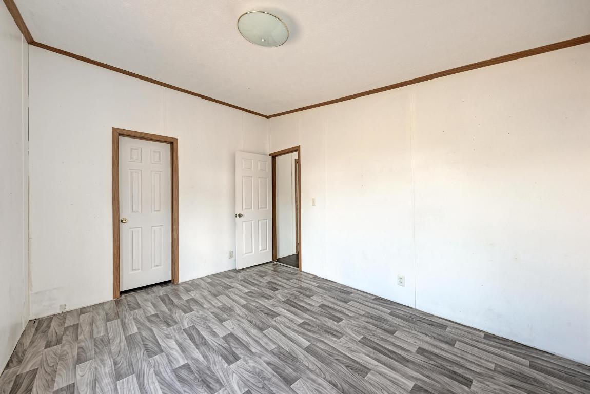 187 Horseshoe Bend Road San Marcos, TX 78666 - Photo 26 of 38 Unfurnished room featuring ornamental molding and wood finished floors