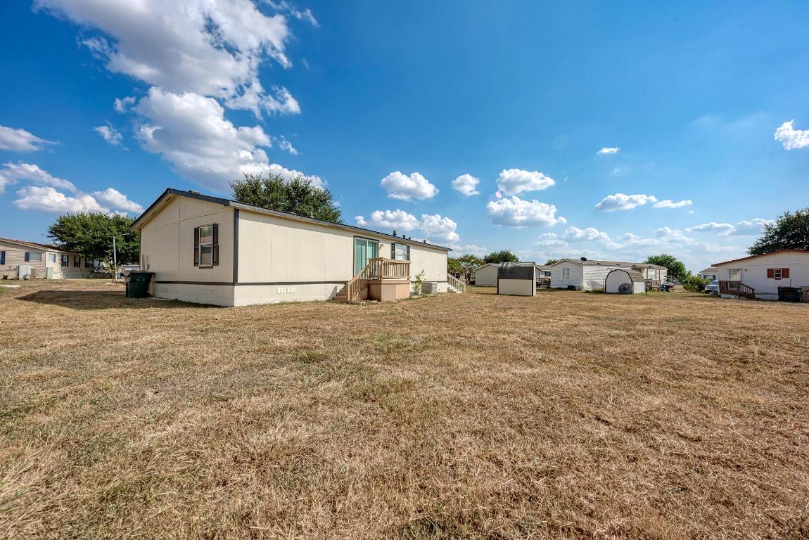 187 Horseshoe Bend Road San Marcos, TX 78666 - Photo 29 of 38 Rear view of house featuring a lawn and crawl space