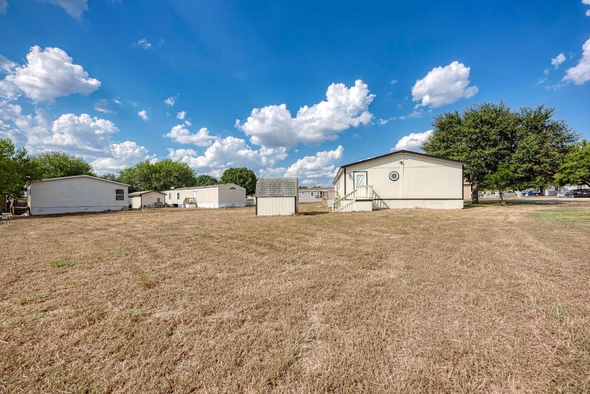 187 Horseshoe Bend Road San Marcos, TX 78666 - Photo 31 of 38 View of green lawn with a shed