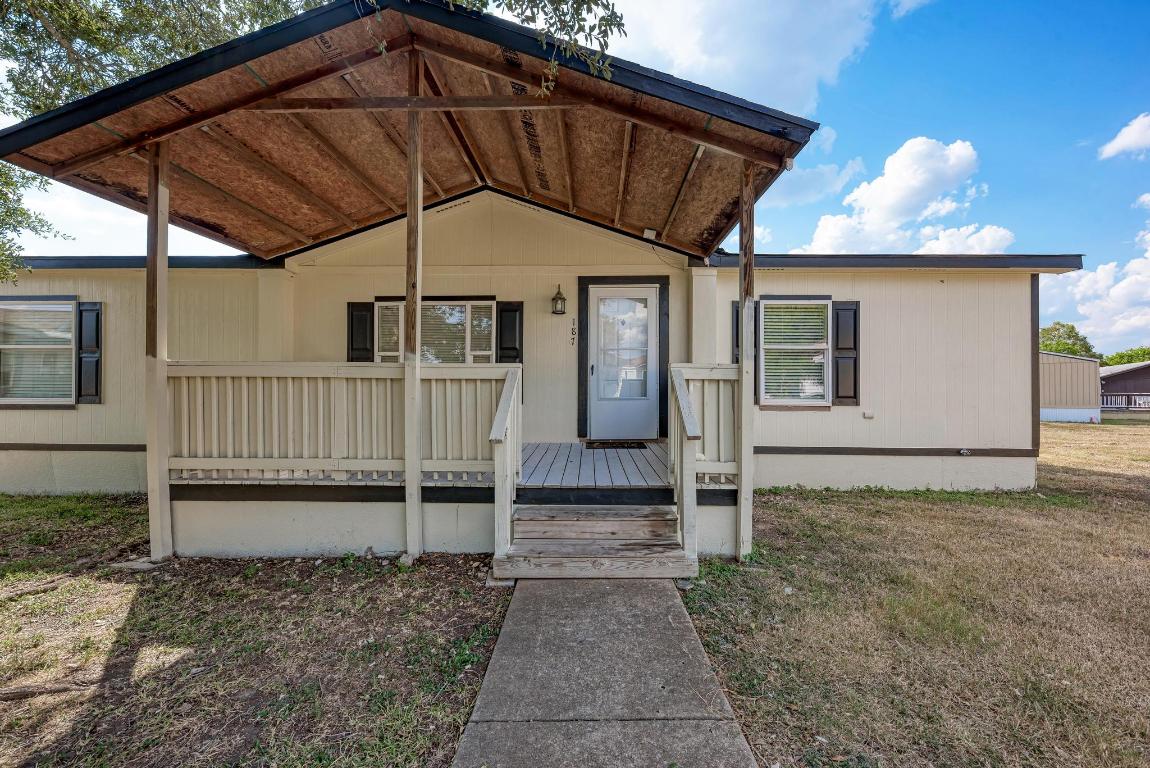 187 Horseshoe Bend Road San Marcos, TX 78666 - Photo 5 of 38 Property entrance with a deck and a yard