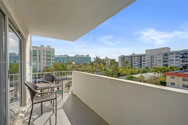 a kitchen with kitchen island granite countertop a sink a counter top space appliances and cabinets