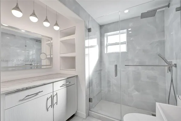 a bathroom with a sink toilet and shower