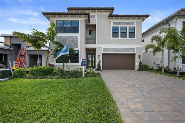 a front view of a house with a yard and garage
