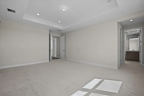 an empty room with a bench and a window