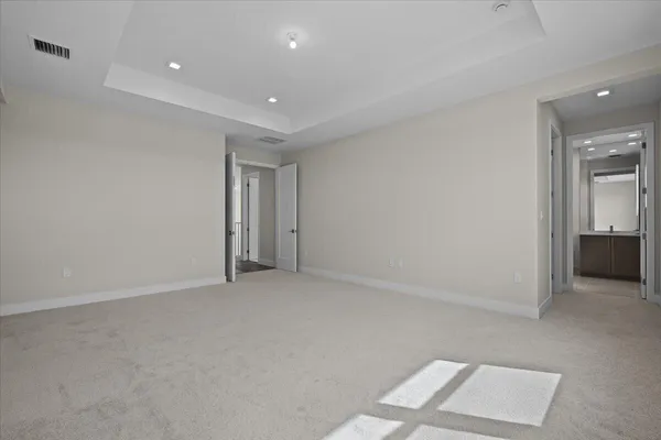 an empty room with a bench and a window