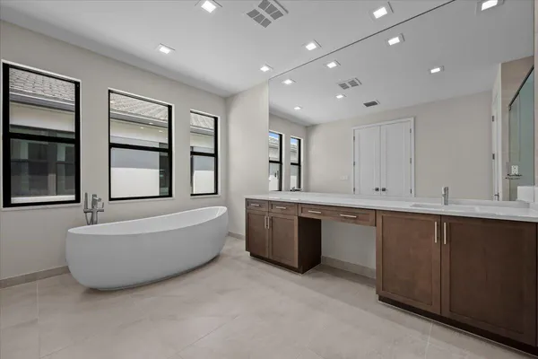 a large living room with stainless steel appliances granite countertop a sink dishwasher a stove and a refrigerator with wooden floor