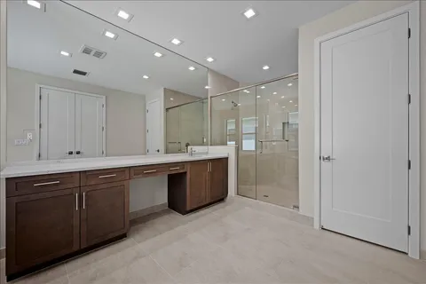 a large bathroom with a large tub sink shower and cabinets