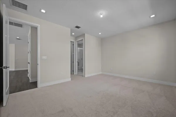an empty room with closet and a bathroom