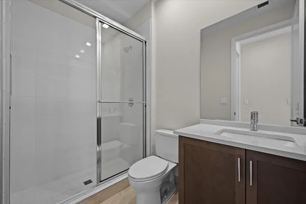 a bathroom with a sink toilet and shower