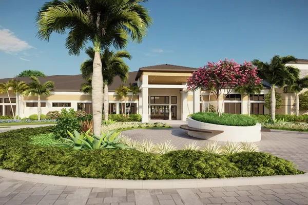 front view of a house with a yard and potted plants