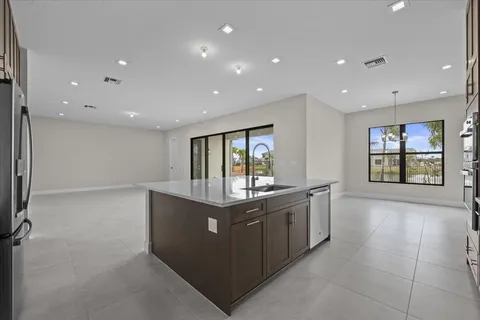 a large kitchen with stainless steel appliances granite countertop a large counter top and a stove