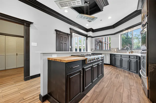 a kitchen with stainless steel appliances granite countertop a stove and a sink