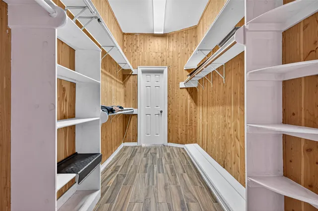 a view of walk in closet with empty room