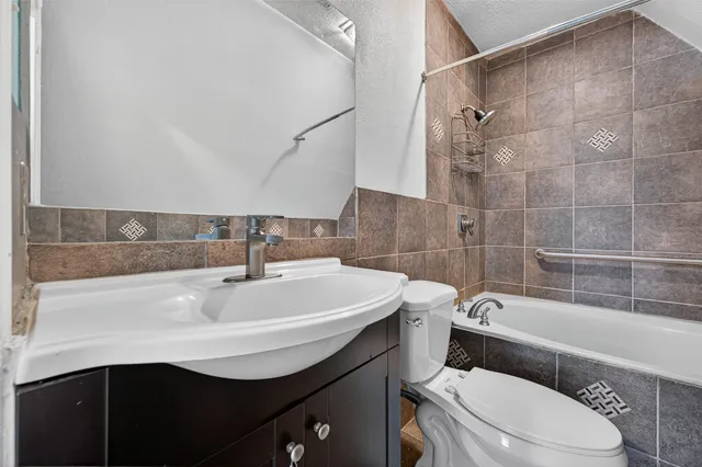 a bathroom with a sink a toilet and bathtub