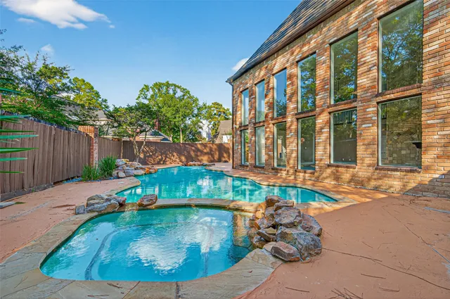 a backyard of a house with outdoor seating