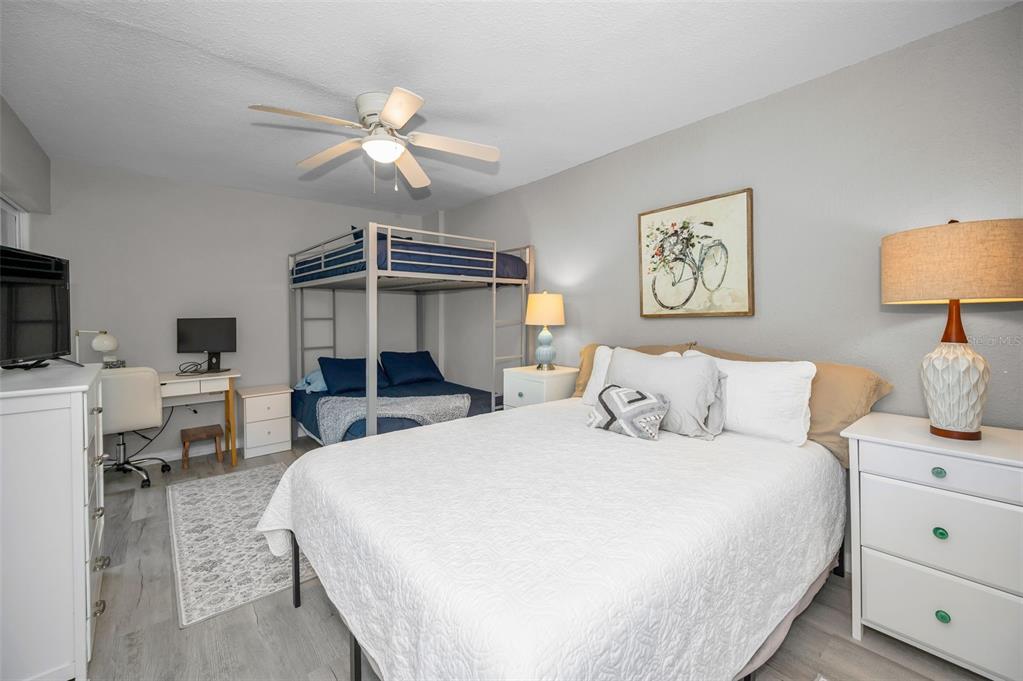 203 Tarpon Point, Unit 203 Tarpon Springs, FL 34689 - Photo 26 of 39 a bedroom with a bed and a chandelier