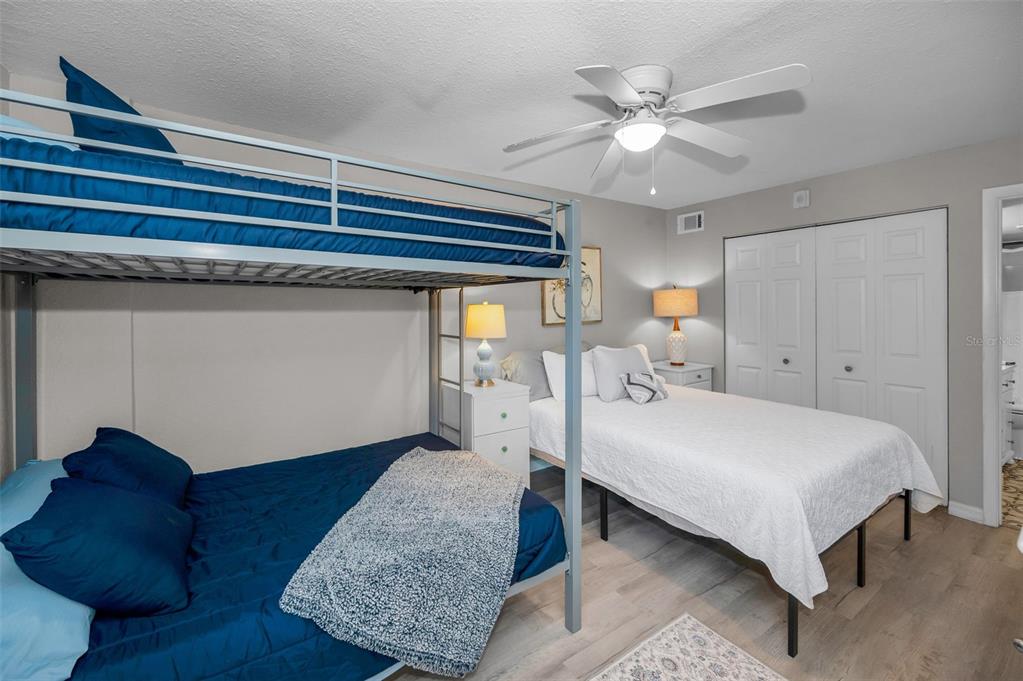 203 Tarpon Point, Unit 203 Tarpon Springs, FL 34689 - Photo 28 of 39 a bed room with a bed and a chandelier