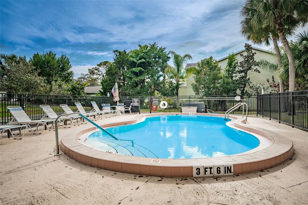 203 Tarpon Point, Unit 203 Tarpon Springs, FL 34689 - Photo 32 of 39 a view of a swimming pool with a patio
